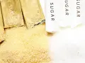 Złoty cukier trzcinowy obok białego. Czy cukier trzcinowy jest zdrowszy? Zobaczmy, co kryje się w opakowaniach z napisem "SUGAR".